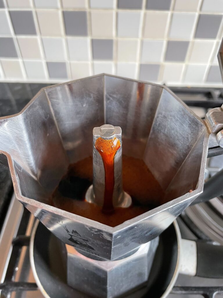 Freshley brewed coffee oozing from the spout inside my Bialetti Moka Express
